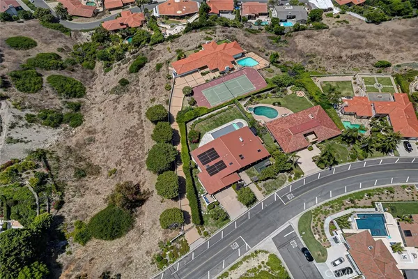 an aerial view of a house with a yard