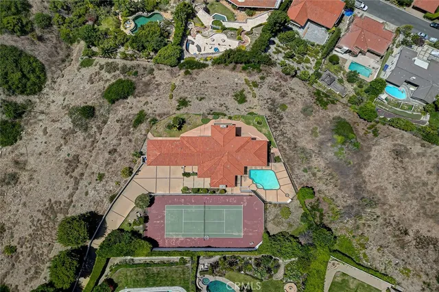 an aerial view of a house with a garden and trees
