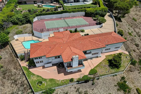 an aerial view of a house with garden space and street view