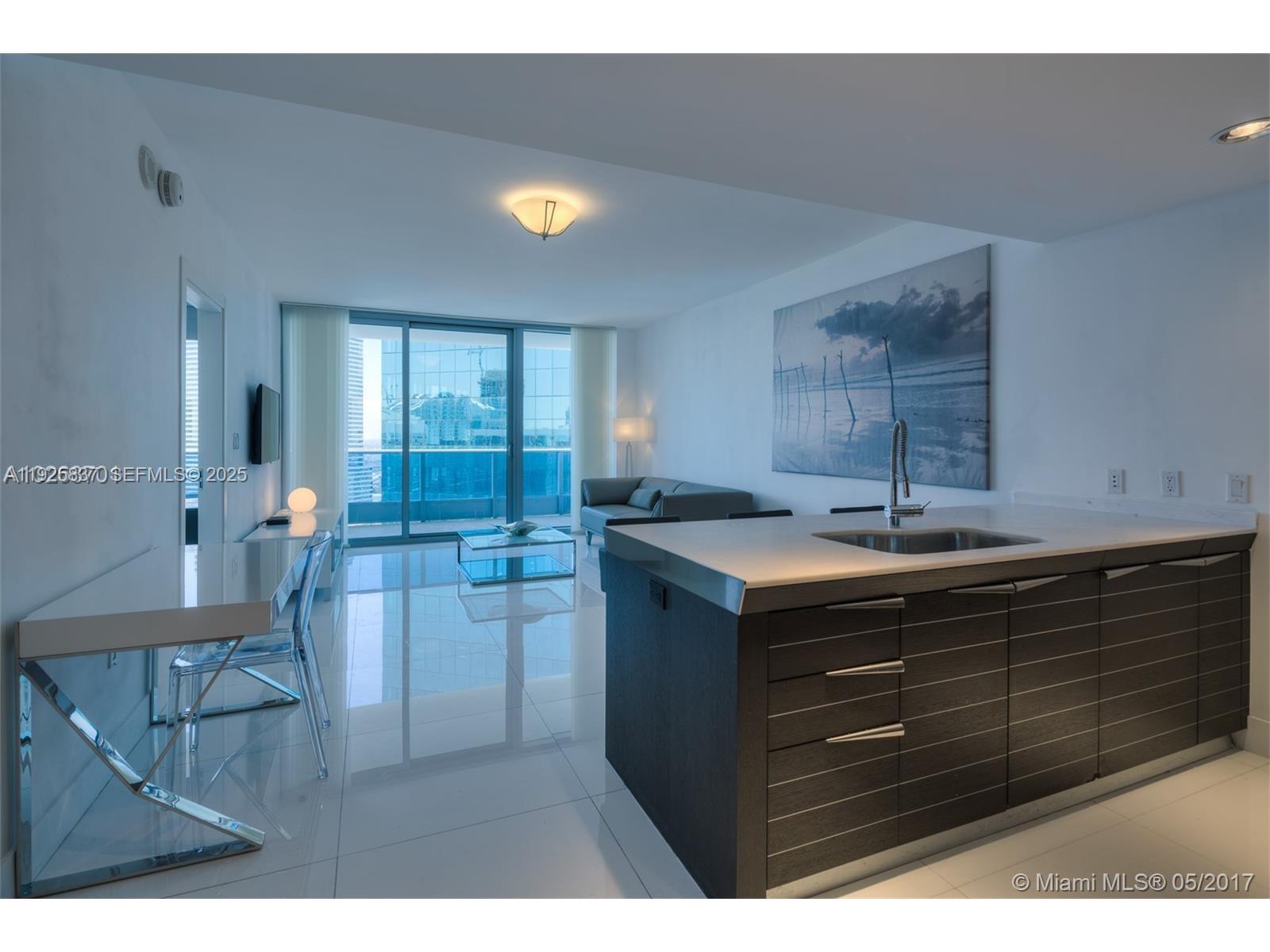 200 Biscayne Blvd Way, Unit 4309 Miami, FL 33131 - Photo 1 of 10 a kitchen with a sink and cabinets