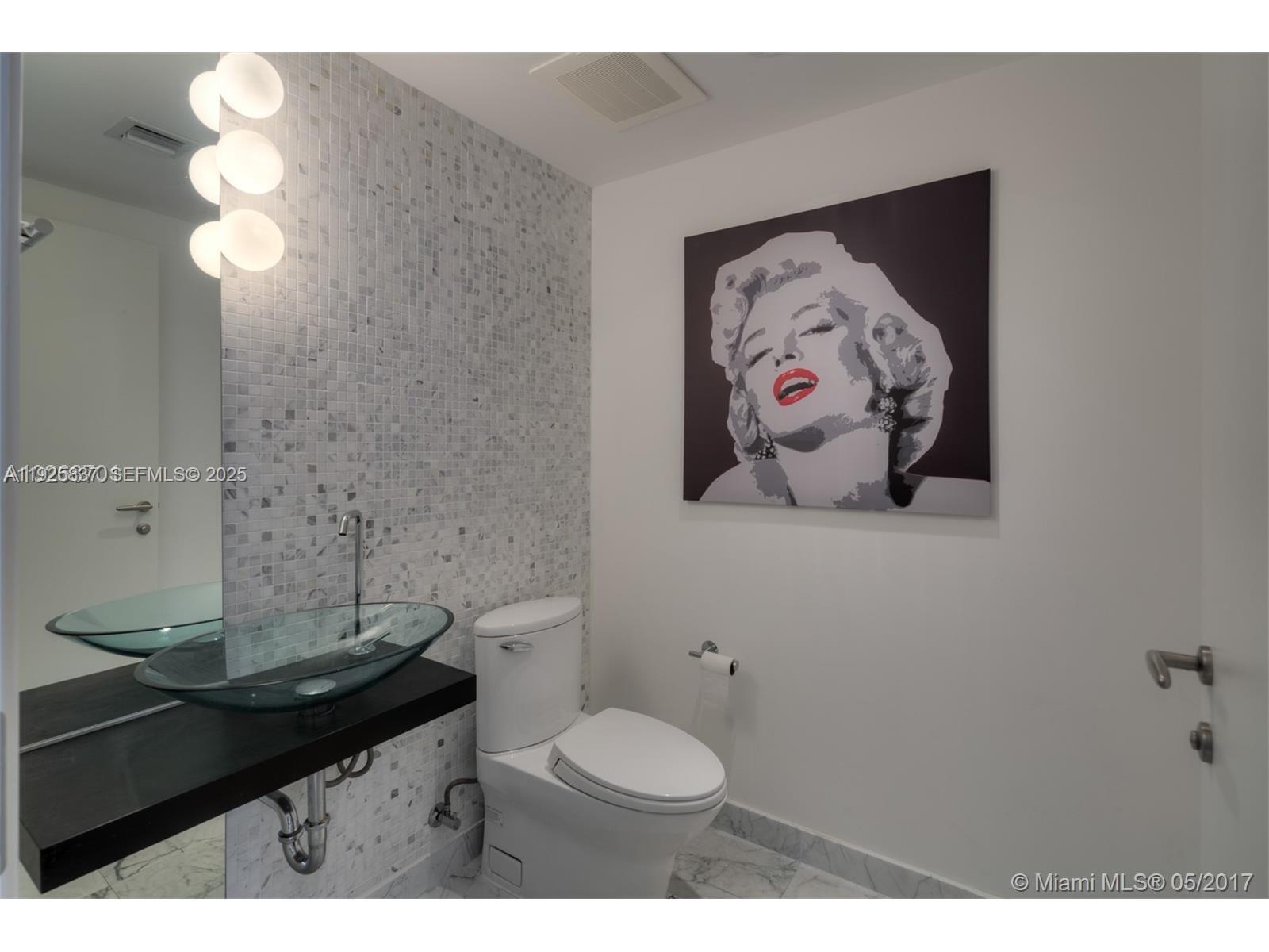 200 Biscayne Blvd Way, Unit 4309 Miami, FL 33131 - Photo 7 of 10 a bathroom with a sink and a mirror