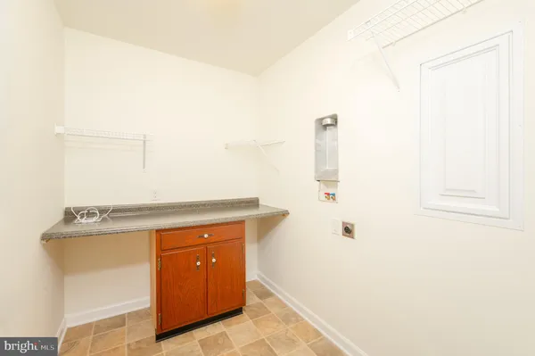 view of a utility room with closet