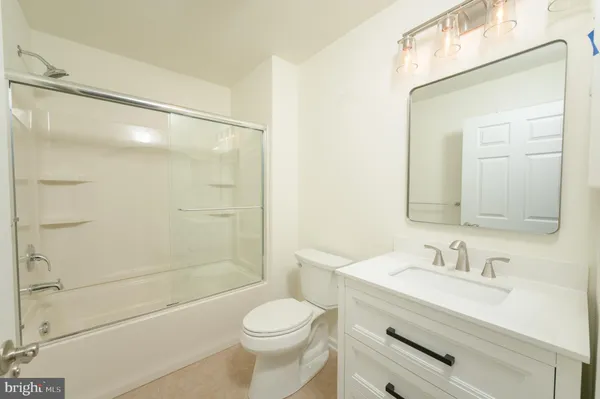 a view of a big room with wooden floor and a ceiling fan