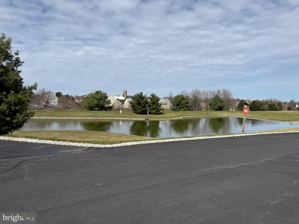 a view of a lake with houses in the back