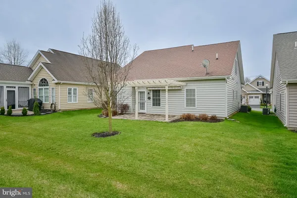 a view of house with backyard
