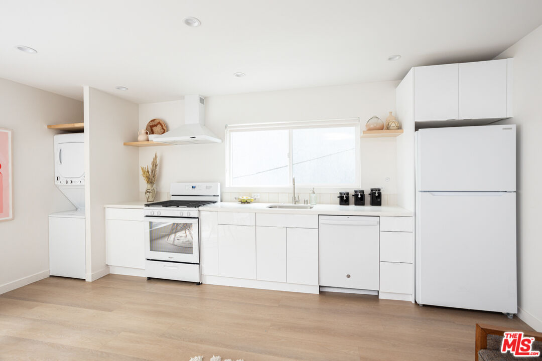 1948 1/2 Preston Avenue Los Angeles, CA 90026 - Photo 5 of 10 a kitchen with white cabinets and white appliances