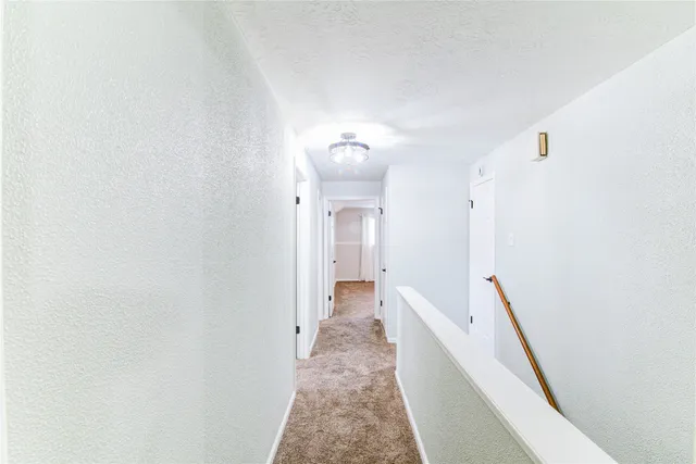 a view of a hallway with white walls