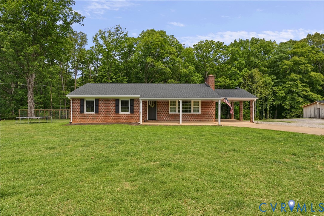81 Rock Creek Road Cumberland, VA 23040 - Photo 1 of 45 a front view of a house with a garden