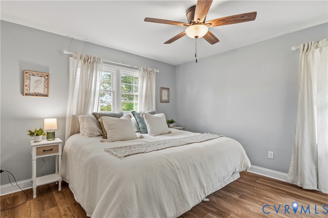 81 Rock Creek Road Cumberland, VA 23040 - Photo 14 of 45 a bedroom with a large bed and a ceiling fan