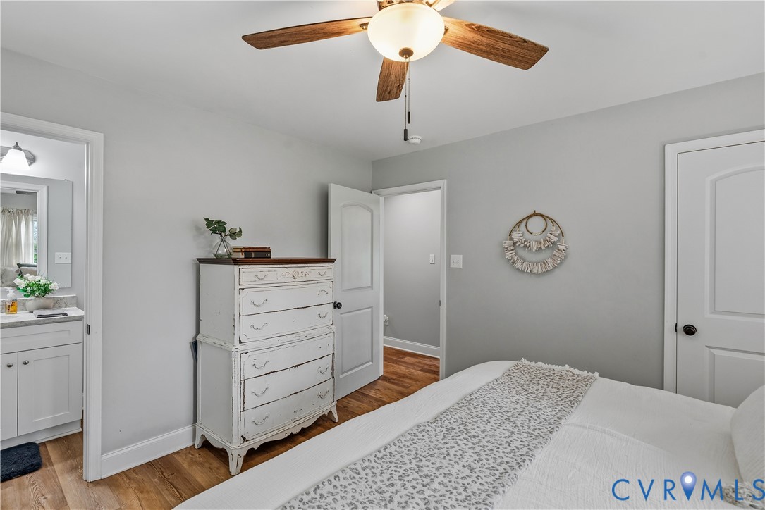 81 Rock Creek Road Cumberland, VA 23040 - Photo 16 of 45 a bedroom with a bed and a chandelier