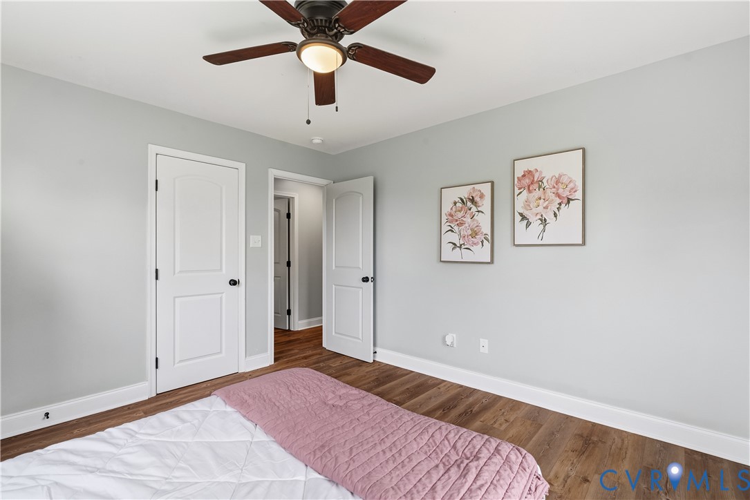81 Rock Creek Road Cumberland, VA 23040 - Photo 20 of 45 a bedroom with a large bed and a chandelier fan