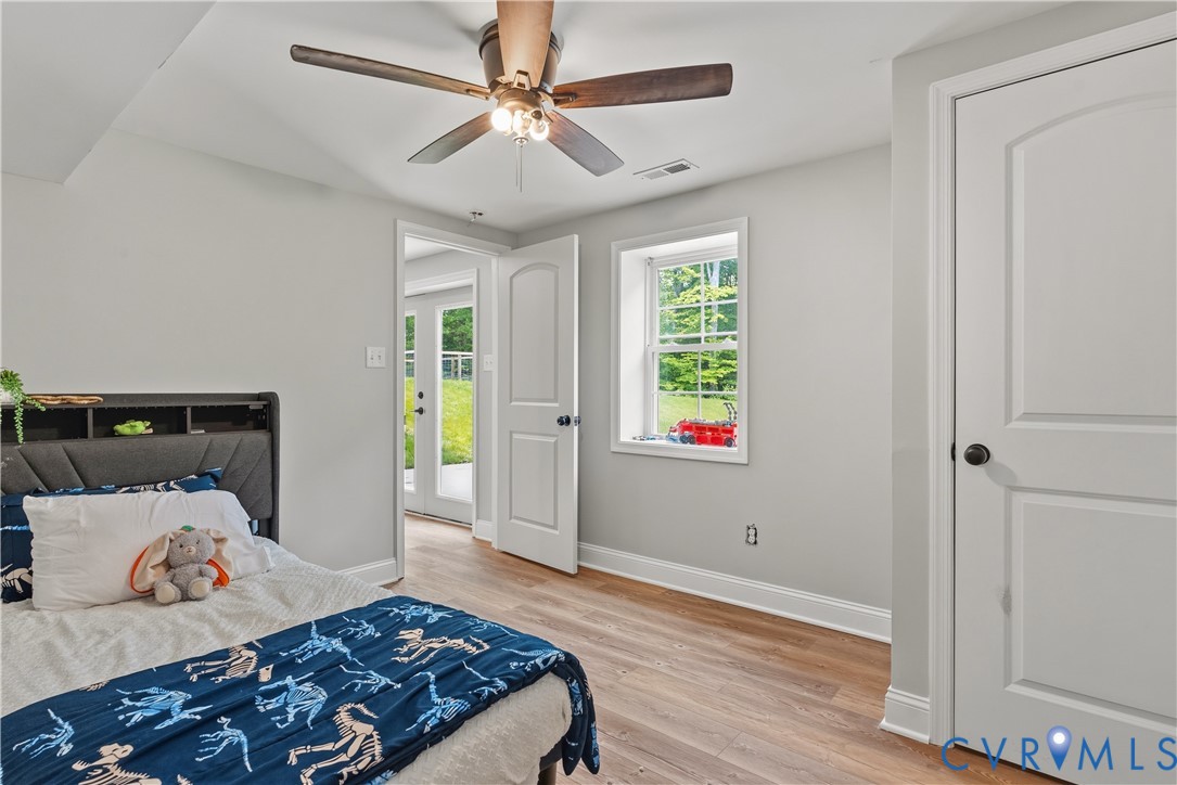 81 Rock Creek Road Cumberland, VA 23040 - Photo 25 of 45 a bedroom with a bed and wooden floor