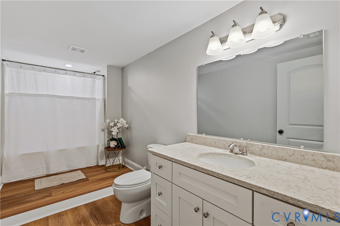 81 Rock Creek Road Cumberland, VA 23040 - Photo 26 of 45 a bathroom with a sink vanity granite toilet and a mirror
