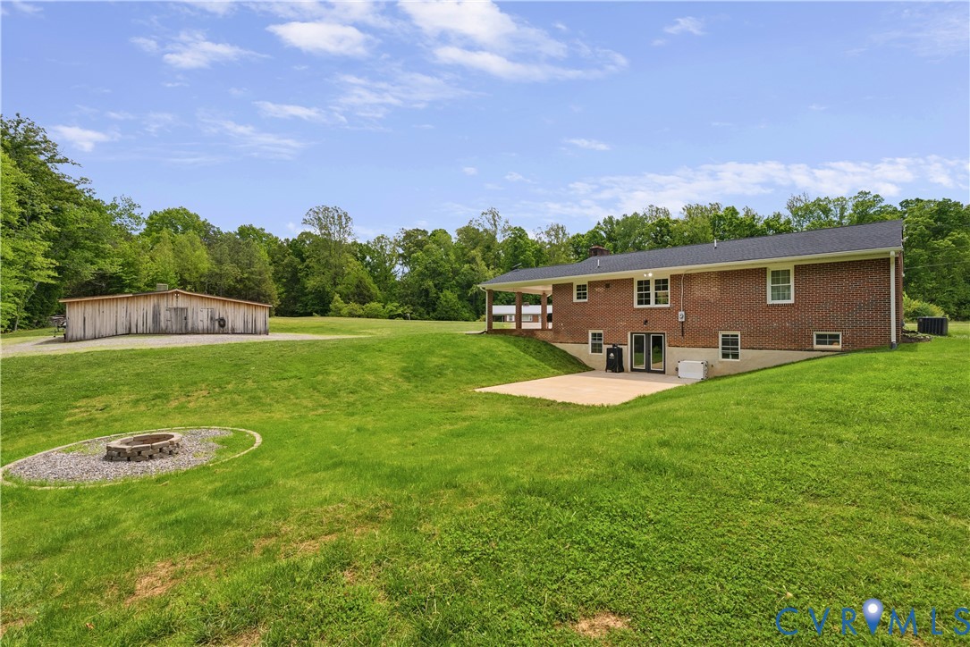 81 Rock Creek Road Cumberland, VA 23040 - Photo 37 of 45 a view of a house with a backyard porch and furniture