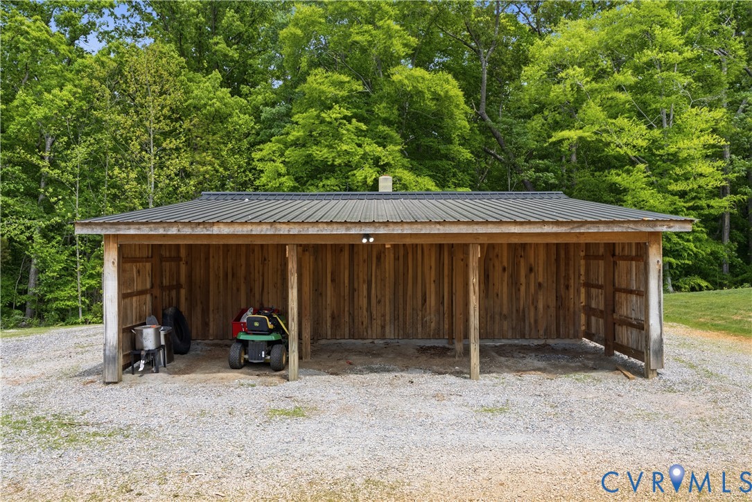 81 Rock Creek Road Cumberland, VA 23040 - Photo 42 of 45 a view of a wooden house with large trees and wooden fence