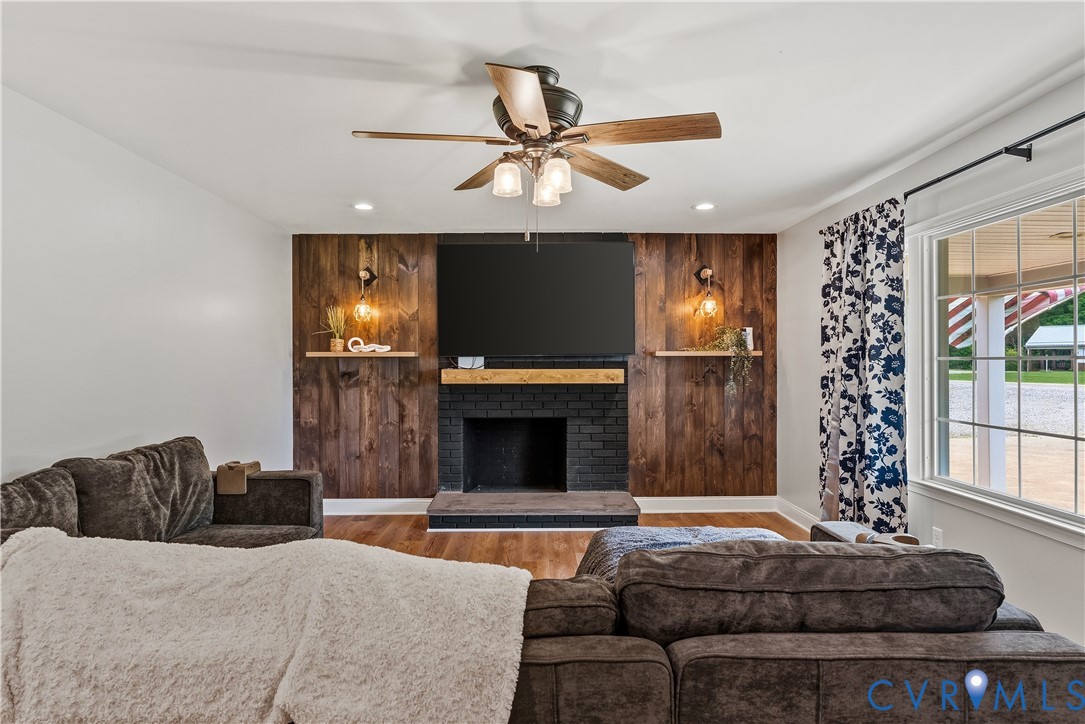 81 Rock Creek Road Cumberland, VA 23040 - Photo 5 of 45 a living room with furniture a fireplace and a flat screen tv