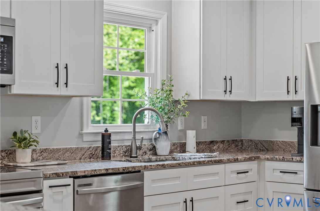 81 Rock Creek Road Cumberland, VA 23040 - Photo 9 of 45 a kitchen with granite countertop a sink and white cabinets