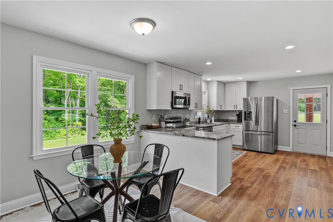 81 Rock Creek Road Cumberland, VA 23040 - Photo 10 of 45 a kitchen with refrigerator and chairs