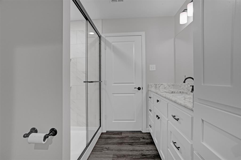 399 South Main Street Blue Ridge, TX 75424 - Photo 12 of 25 a bathroom with a double vanity sink and mirror