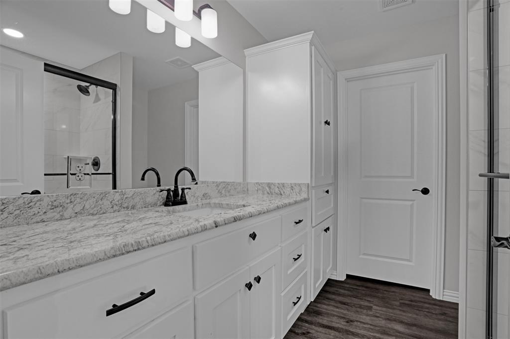 399 South Main Street Blue Ridge, TX 75424 - Photo 13 of 25 a bathroom with a granite countertop sink mirror and vanity