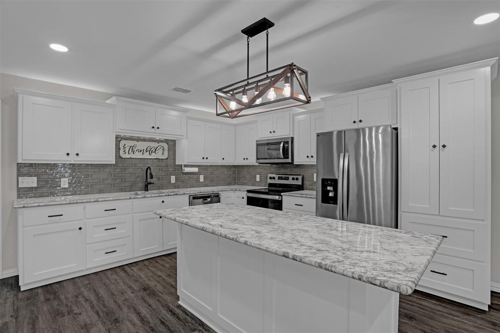 399 South Main Street Blue Ridge, TX 75424 - Photo 6 of 25 a kitchen with stainless steel appliances granite countertop a sink refrigerator stove and microwave