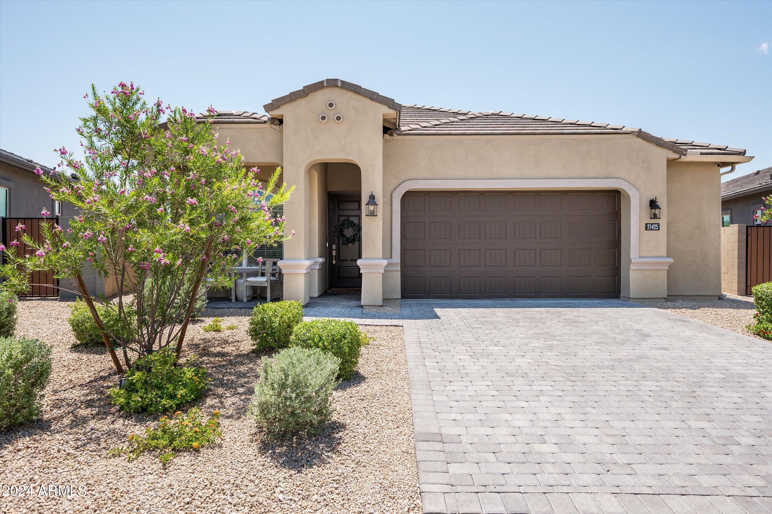 21425 North 59th Street Phoenix, AZ 85054 - Photo 1 of 47 a front view of a house with a yard and garage