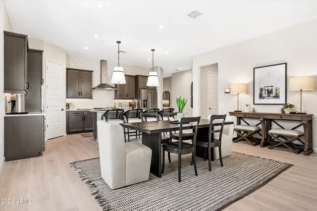 a large kitchen with a table and chairs