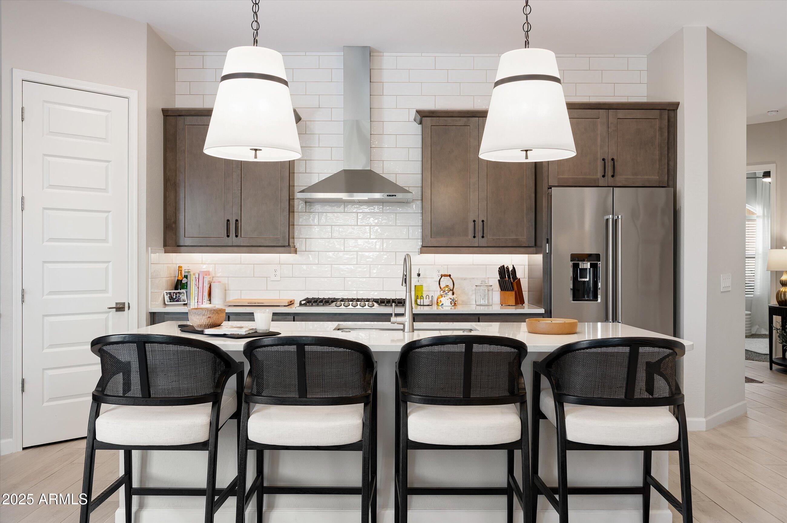 21425 North 59th Street Phoenix, AZ 85054 - Photo 12 of 47 a kitchen with granite countertop a sink cabinets and chairs in it