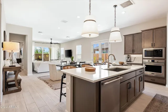 a kitchen with sink stove and cabinets