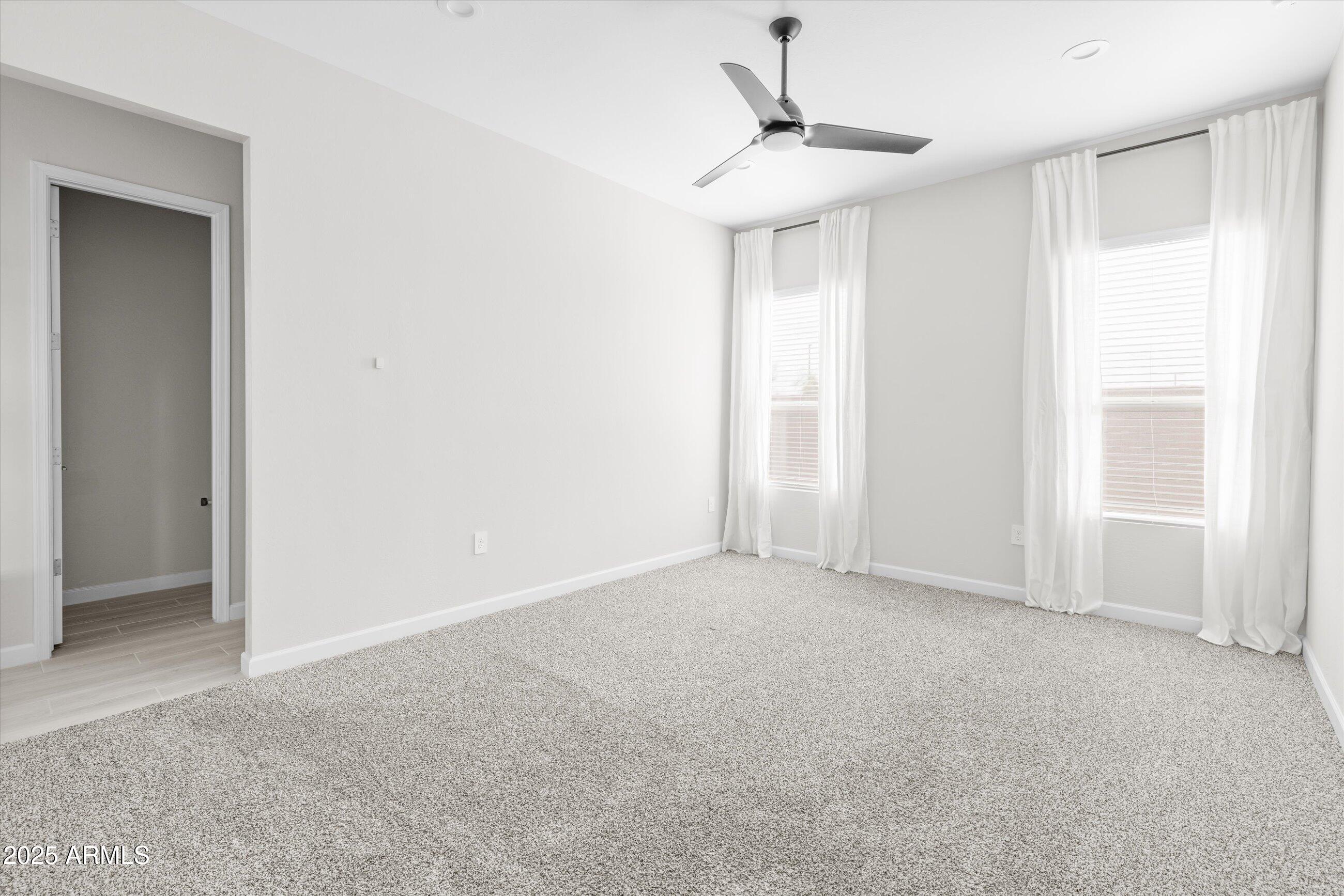 21425 North 59th Street Phoenix, AZ 85054 - Photo 19 of 47 a view of an empty room and a chandelier fan