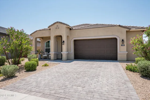 a front view of a house with a yard and garage