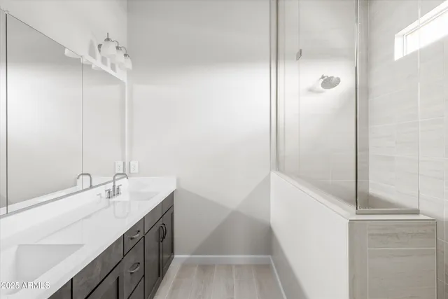 a bathroom with a tub sink and mirror