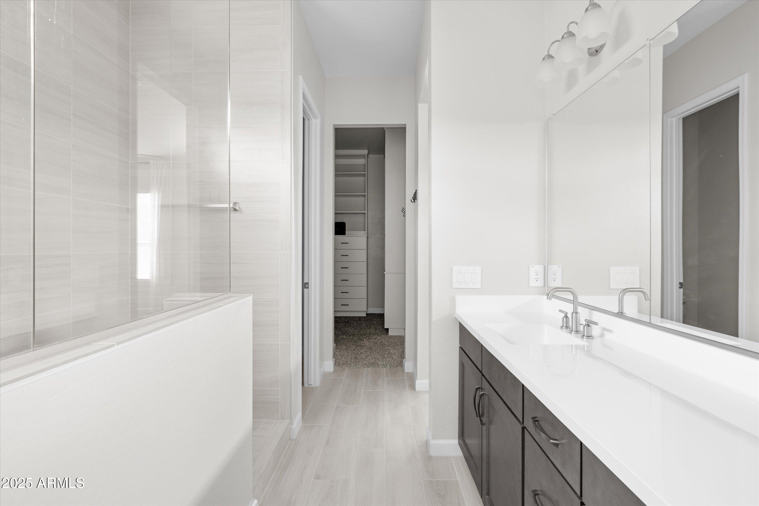 21425 North 59th Street Phoenix, AZ 85054 - Photo 27 of 47 a bathroom with a double vanity sink a mirror and a bathtub