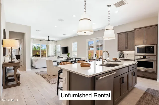 a kitchen with a sink stove and cabinets