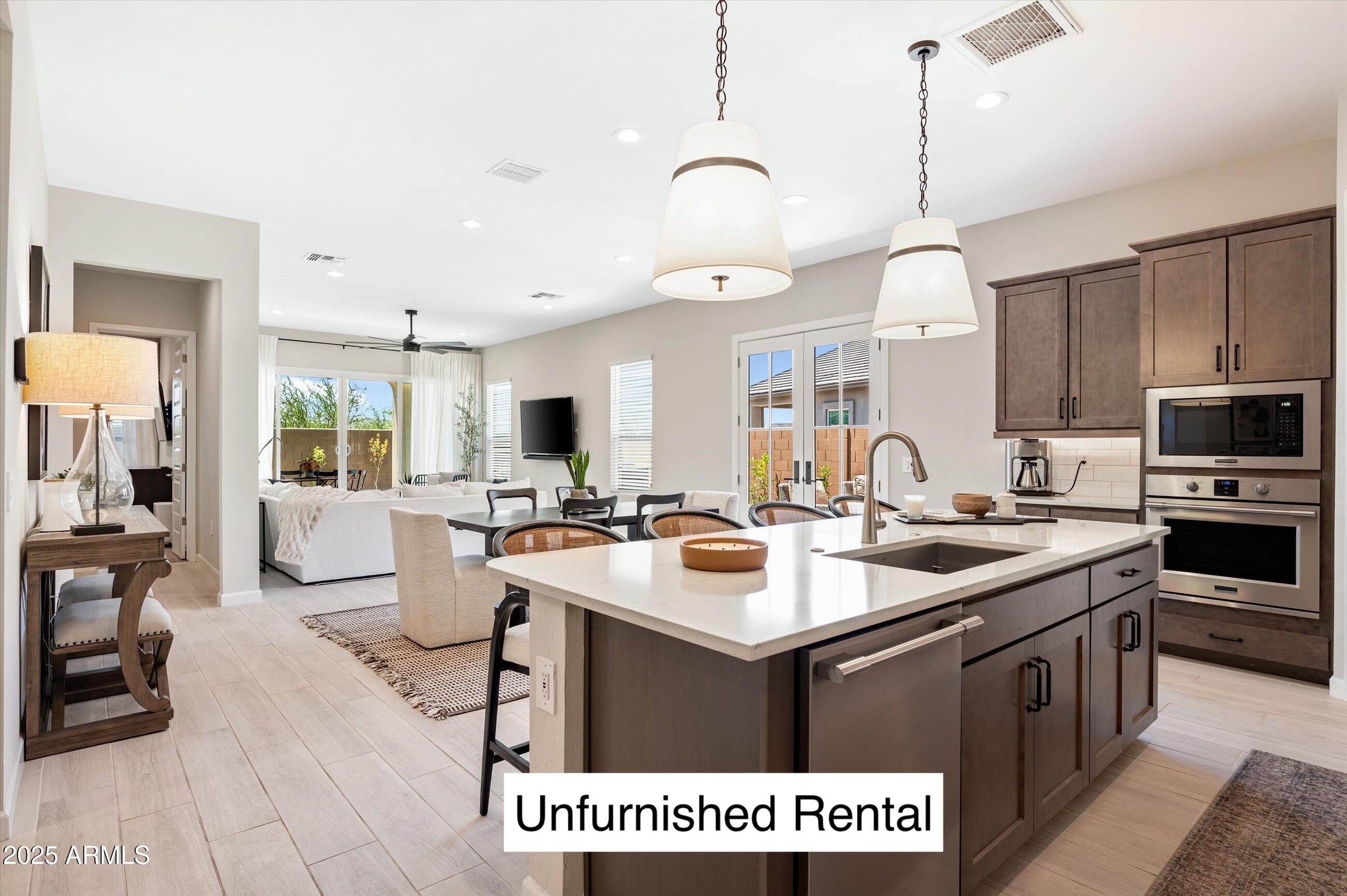 21425 North 59th Street Phoenix, AZ 85054 - Photo 3 of 47 a kitchen with a sink stove and cabinets
