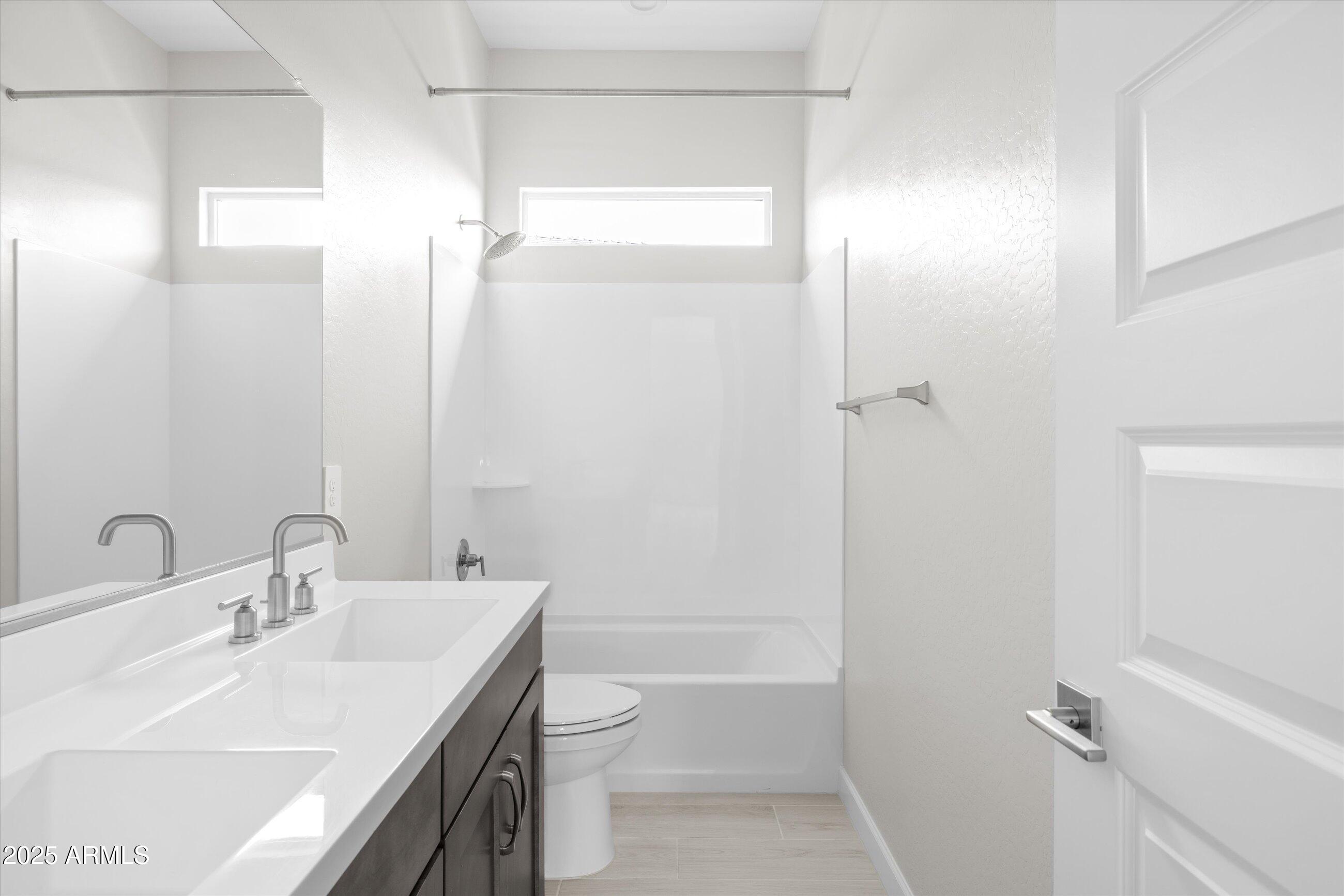 21425 North 59th Street Phoenix, AZ 85054 - Photo 33 of 47 a bathroom with a sink a toilet and shower