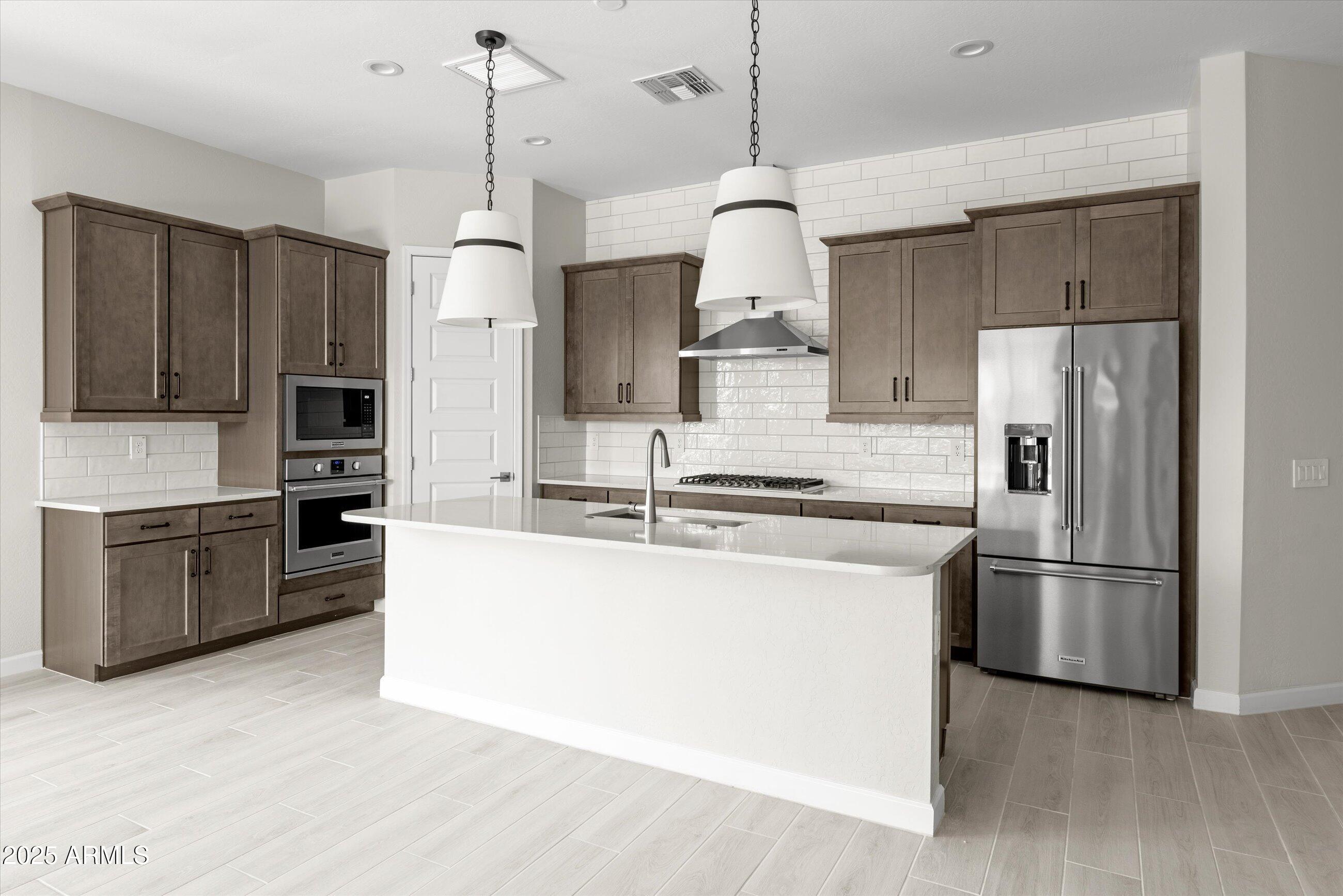 21425 North 59th Street Phoenix, AZ 85054 - Photo 5 of 47 a kitchen with stainless steel appliances granite countertop a refrigerator a stove a sink and a refrigerator