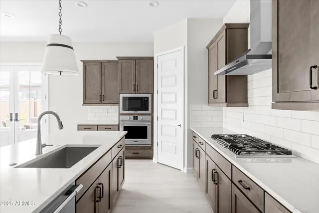 a kitchen with a sink stove and refrigerator