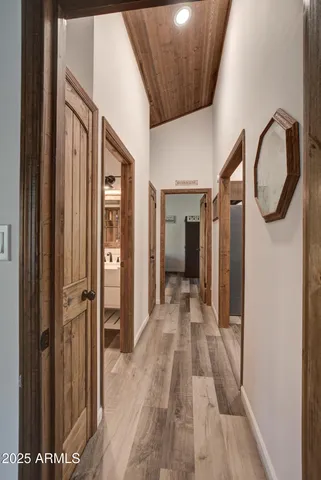 a view of a hallway with wooden floor and entryway