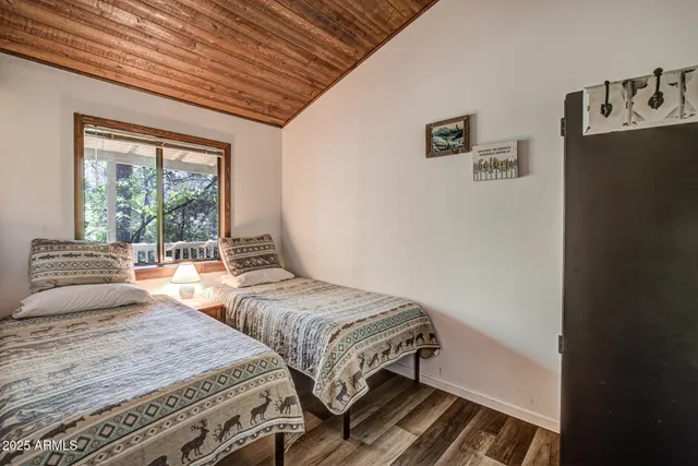 a bedroom with two beds and a large window