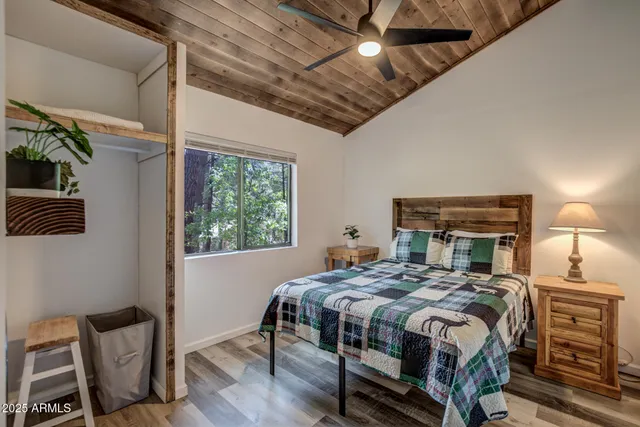 a bedroom with a bed a chandelier and a window