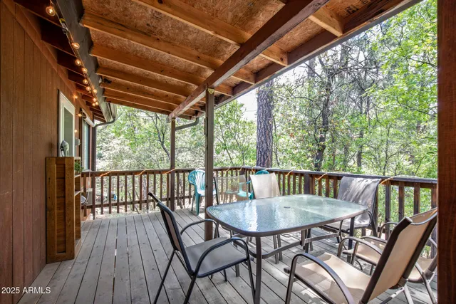 a view of a patio with a table chairs and a backyard