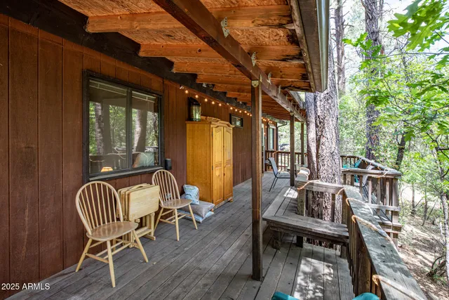 a balcony with wooden floor and outdoor seating