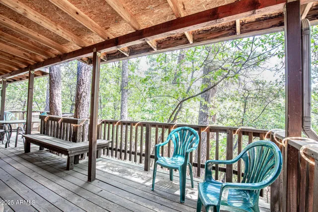 a view of a porch with furniture and wooden deck