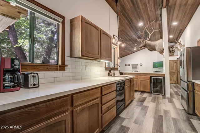 a kitchen with cabinets a sink and appliances