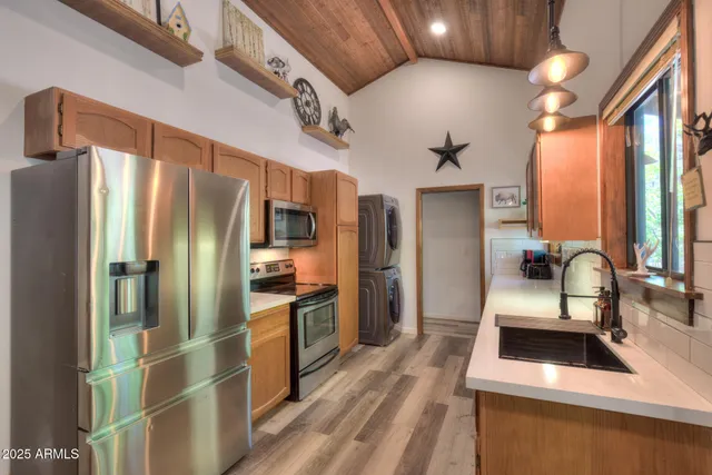 a kitchen with stainless steel appliances a refrigerator and a sink