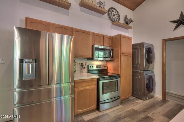a kitchen with stainless steel appliances granite countertop a refrigerator stove and microwave