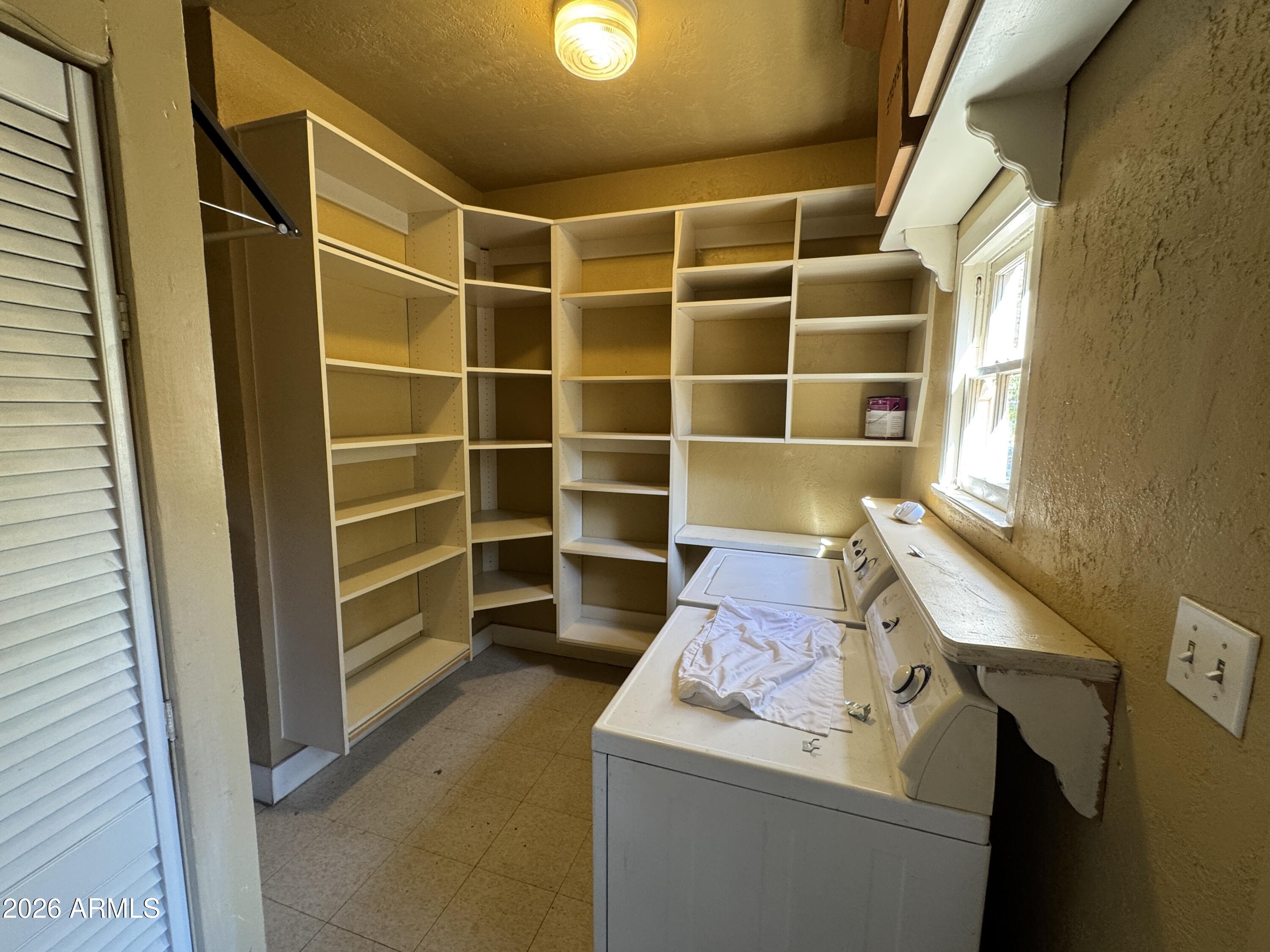 505 West Granada Road Phoenix, AZ 85003 - Photo 14 of 30 a view of storage and utility room with washer and dryer