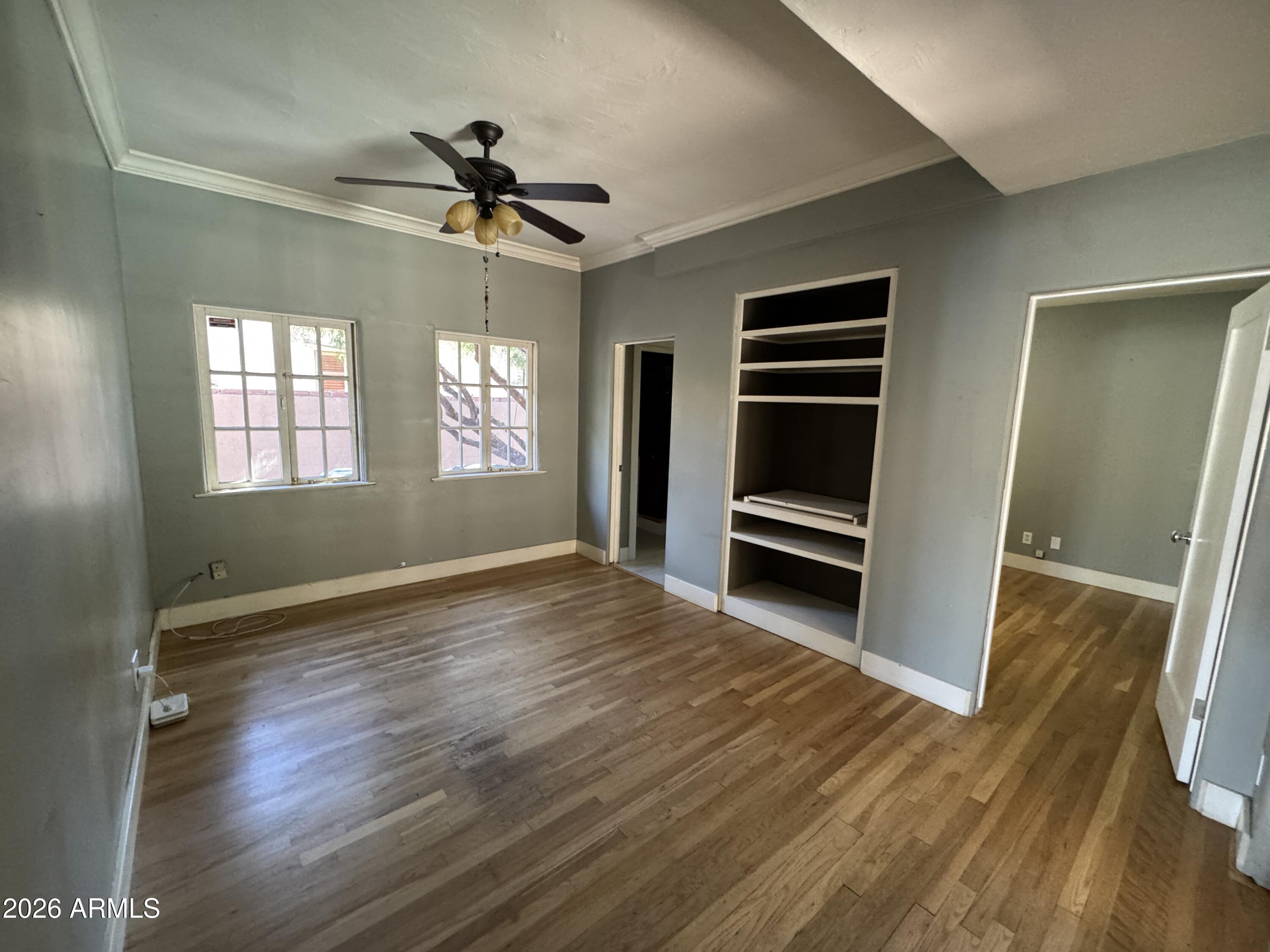 505 West Granada Road Phoenix, AZ 85003 - Photo 17 of 30 a view of an empty room with a window and wooden floor