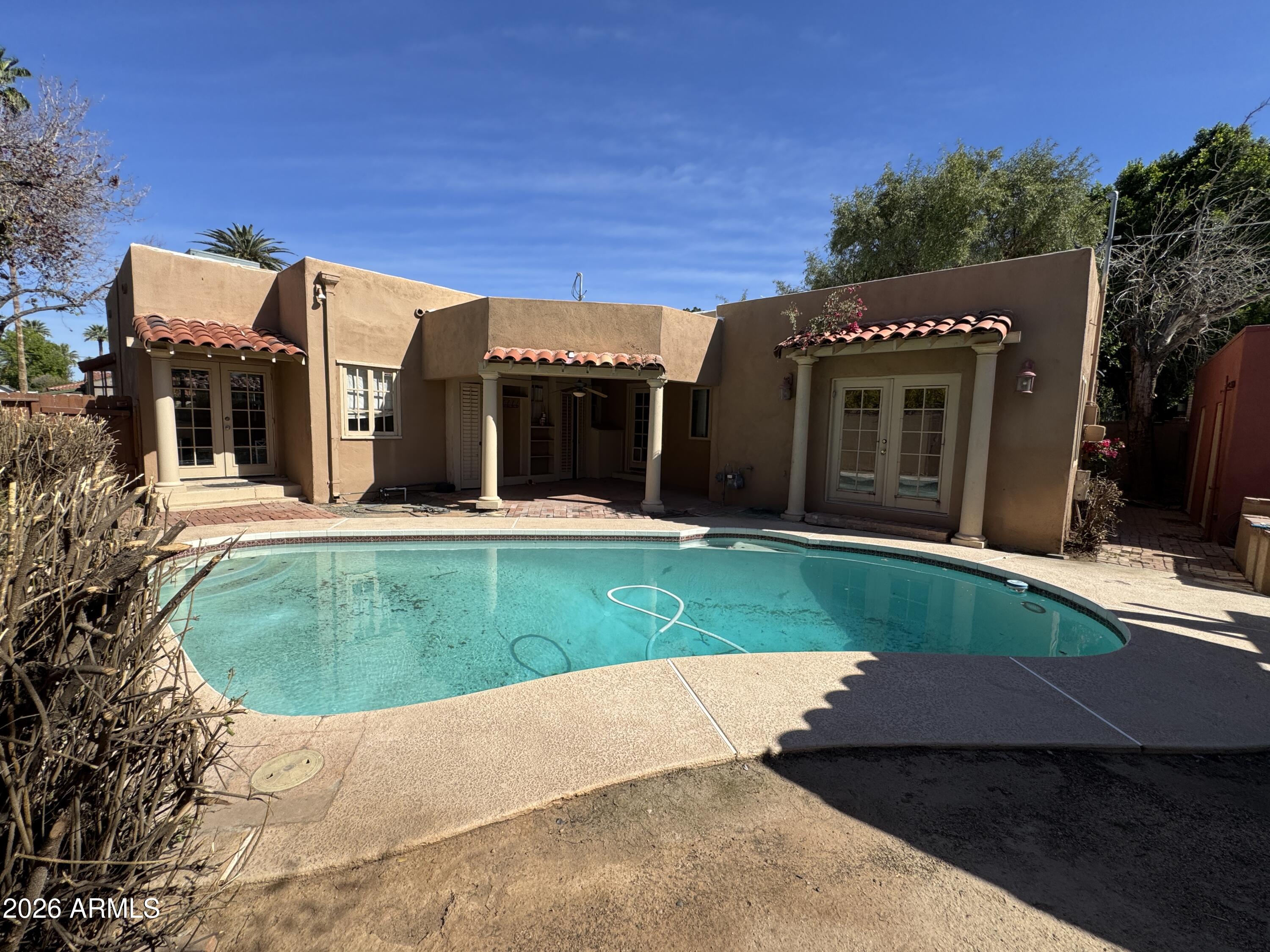 505 West Granada Road Phoenix, AZ 85003 - Photo 24 of 30 a view of a house with a yard and potted plants
